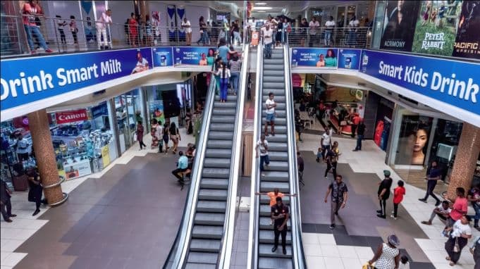 Busy shopping mall with escalators and crowds